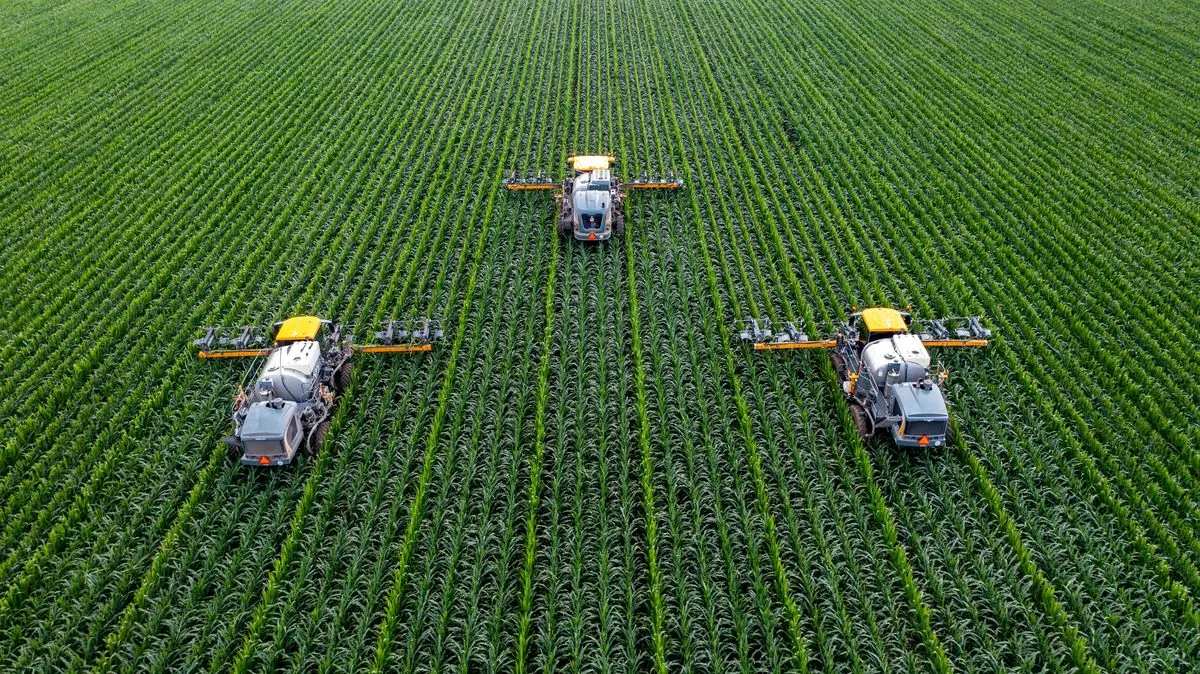 Aerial view of seasonal field rows being worked by machinery, representing short-term and seasonal machinery hire for time-sensitive rural work.